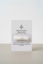 Migraine relief product packaging with visible branding on a neutral surface.