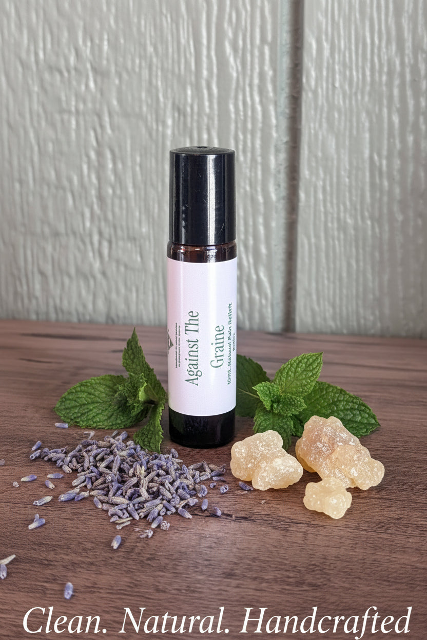 Loose lavender buds, peppermint leaves, and frankincense resin alongside an Against the Graine roller with a clean-ingredients overlay