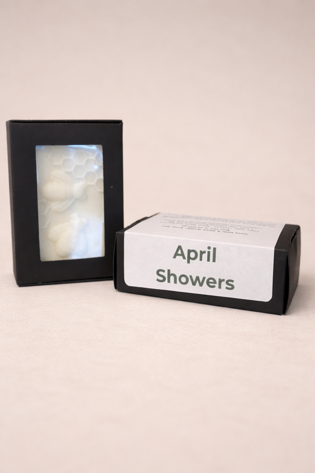 April Showers Goat Milk Soap in a black box on a neutral surface