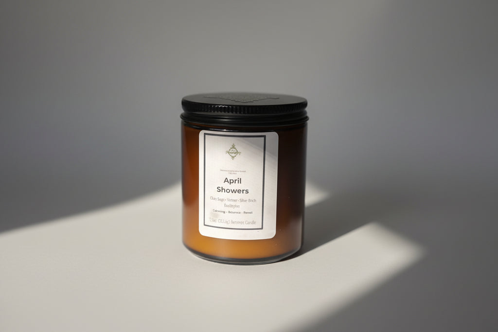 Candle labeled 'April Showers' on a neutral background.