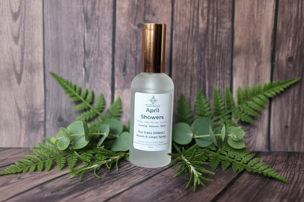 Frosted bottle labeled 'April Showers' on a wooden surface with greenery