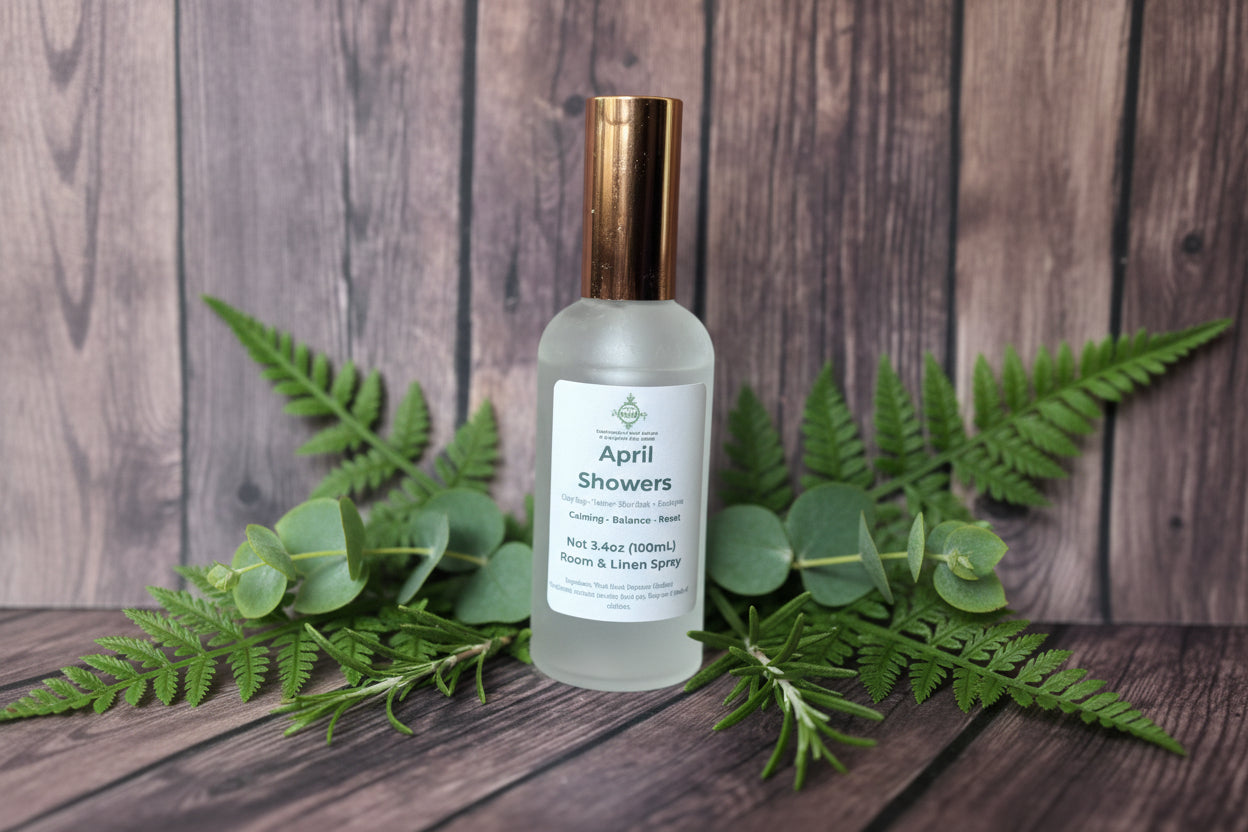 Frosted bottle labeled 'April Showers' on a wooden surface with greenery