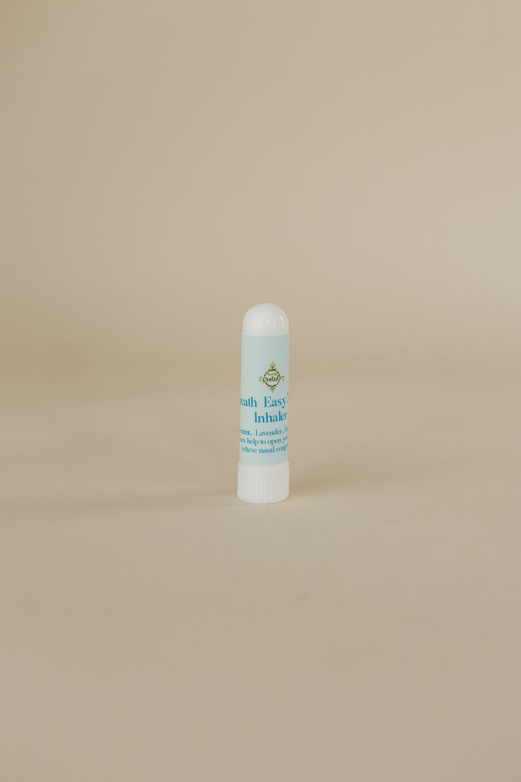 White bottle with blue label on a beige background