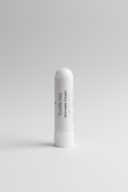 White 'Breathe Easy' aromatic inhaler on a neutral surface with a blurred background