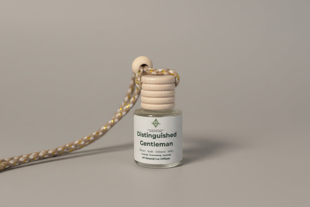 Small bottle with wooden top labeled 'Distinguished Gentleman' on a light surface.