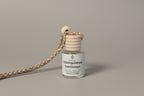 Small bottle with wooden top labeled 'Distinguished Gentleman' on a light surface.