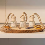 Distinguished Gentleman, Last One Standing and Lavender Lemon Car Diffusers on a wooden plank with lemon slices.  