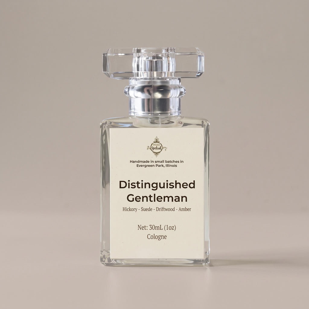 A 30ml clear glass bottle of cologne with a silver cap and a cream-colored label reading 'Distinguished Gentleman'. The bottle is centered against a solid, warm beige background.