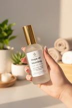 Frosted bottle of Hope of Morning Room and Linen Spray in hand to show size and scale.