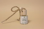 Small bottle labeled 'Hope of Morning' with a strap on a neutral background