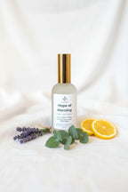 Frosted bottle labeled 'Hope of Morning' with lavender bundle, lemon slices and eucalyptus stems 