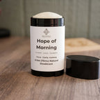 Deodorant with white label on a wooden background 