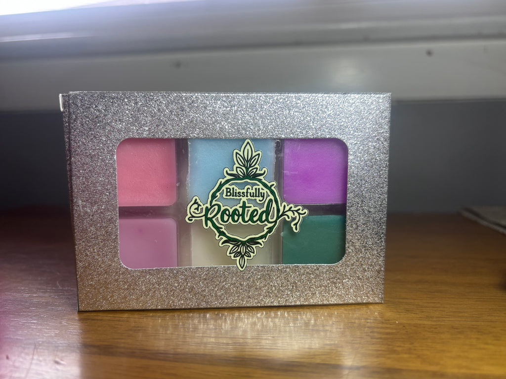 Silver glittery box with colorful product inside on a wooden surface