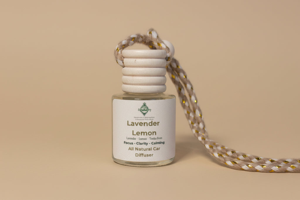 Small glass diffuser bottle labeled 'Lavender Lemon' with a cord on a neutral background