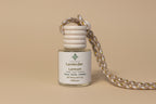 Small glass diffuser bottle labeled 'Lavender Lemon' with a cord on a neutral background