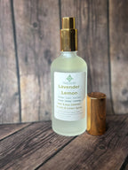 Lavender Lemon spray bottle with gold cap and container on wooden surface