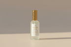 Bottle of Lavender Lemon essential oil on a neutral backgroun.g