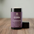 Luxe Cashmere deodorant container on a wooden surface with a neutral background