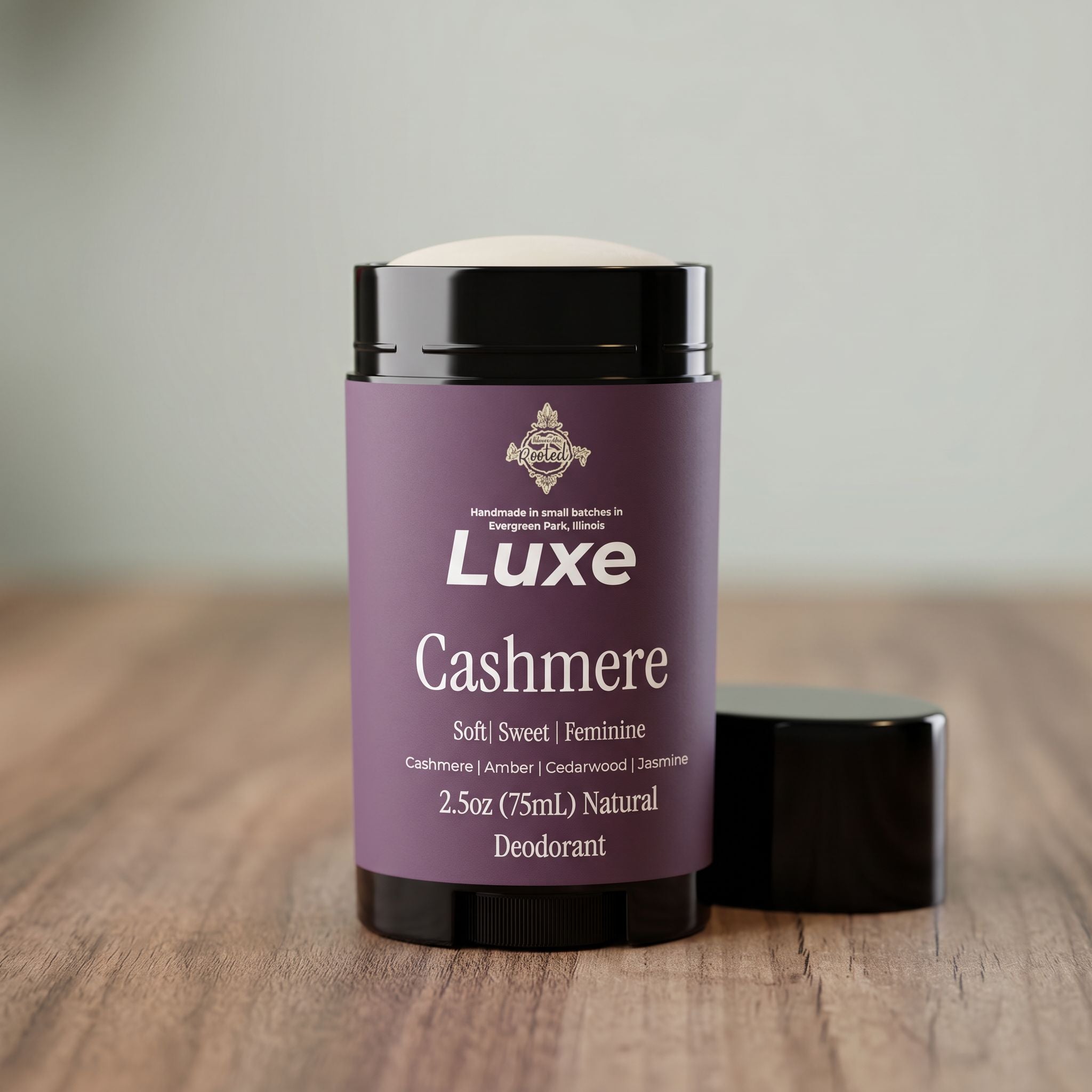Luxe Cashmere deodorant container on a wooden surface with a neutral background