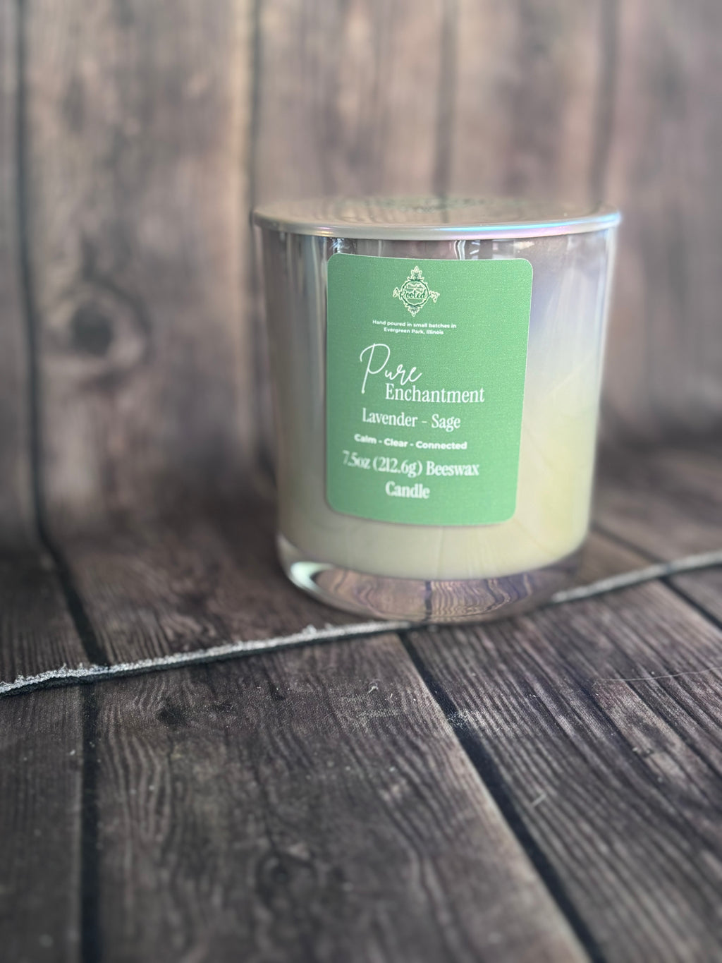 Candle with a green label on a wooden surface