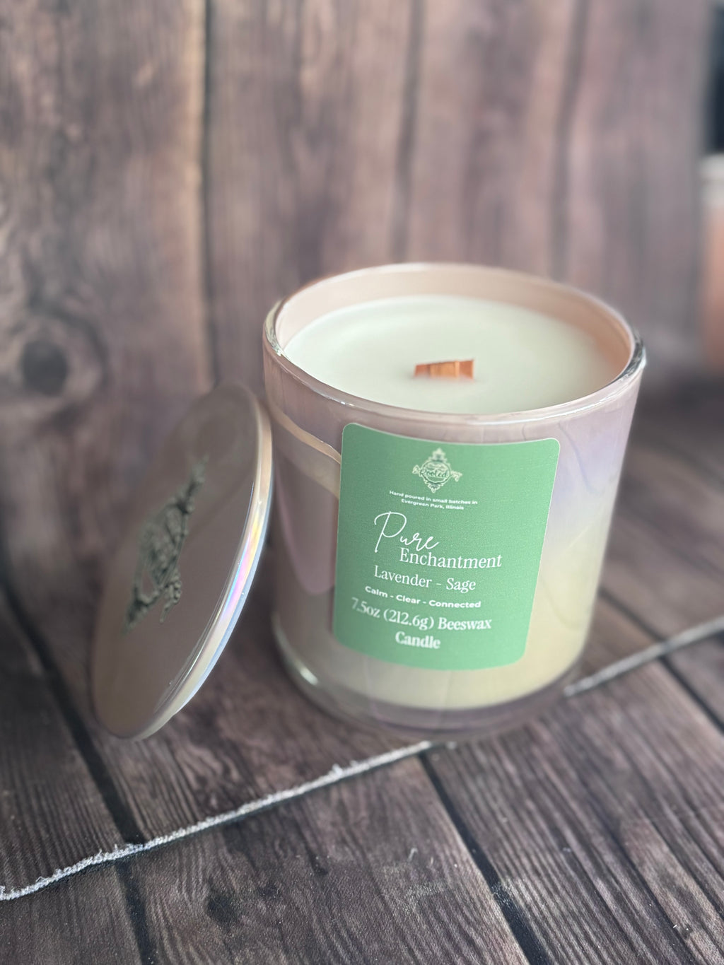 Candle in a glass jar with a green label on a wooden surface