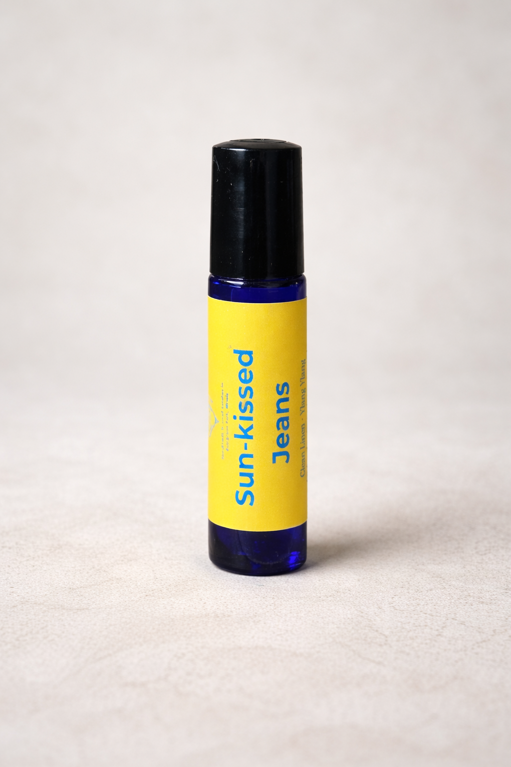 Roll-on bottle labeled 'Sun-kissed Jeans' on a light background
