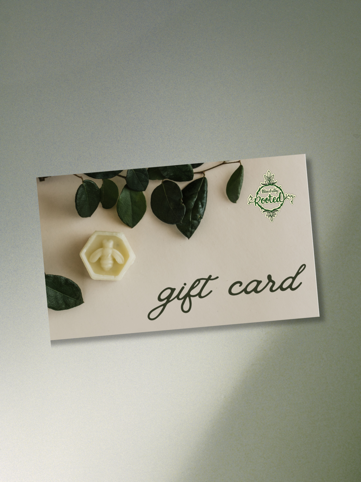 Gift card with floral design and green leaves on a plain background