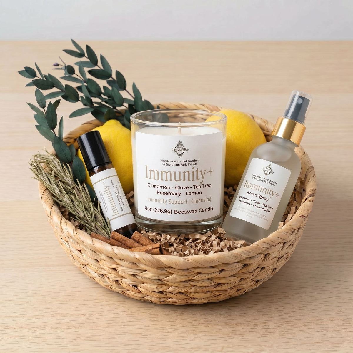 Basket of wellness products including a candle, rollerball, and spray bottle on a wooden surface.