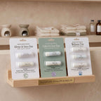 Allergy & Sinus Duo, Calm & Clear Duo and Wellness Trio sets on a wooden shelf in a spa setting.